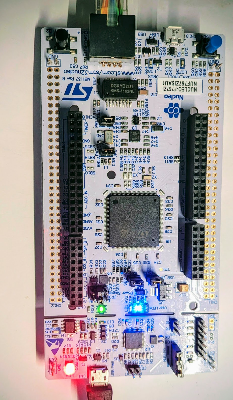 Nucleo-F767ZI board with Ethernet cable running AI-generated bare-metal UDP firmware via RespCode
